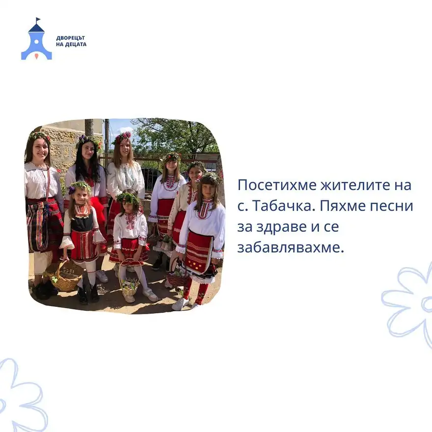 Осем момичета в народни носии с венчета от цветя на главите и плетени кошници в ръце стоят пред каменна сграда в село.